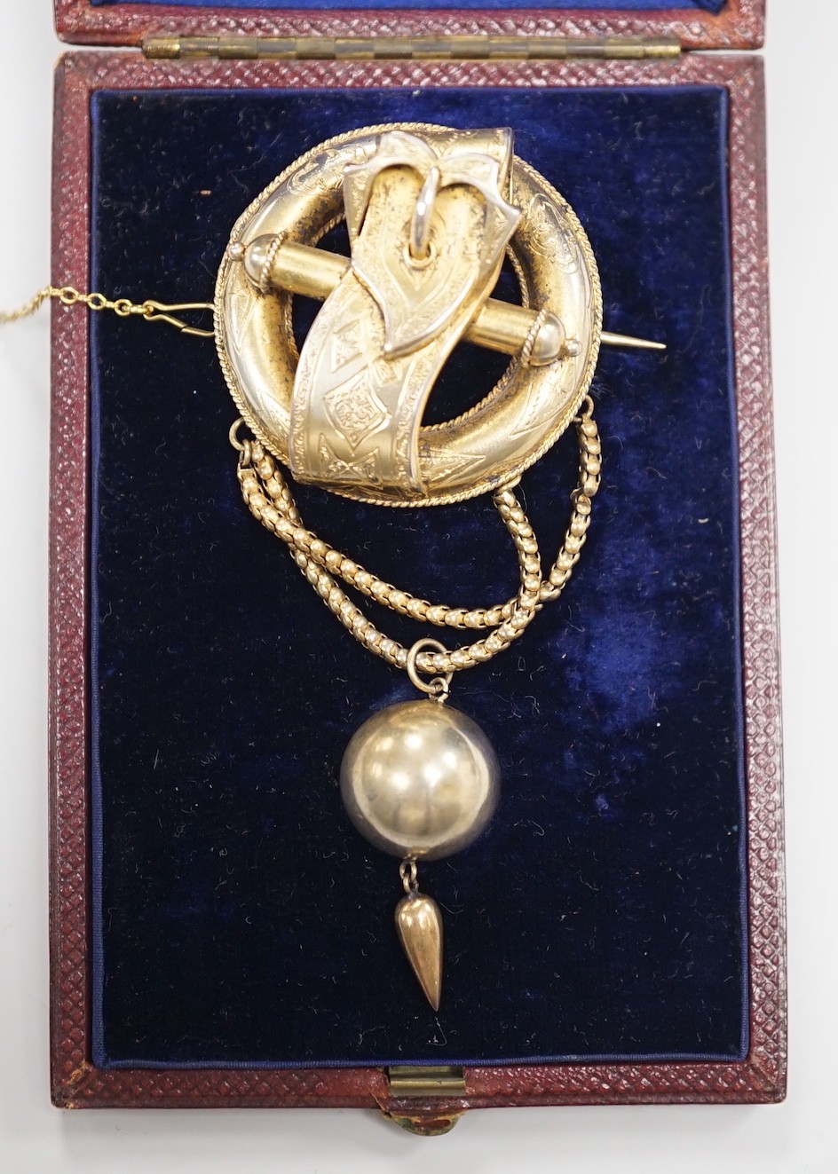 A Victorian gilt white metal drop brooch, with central buckle motif and spherical drop, 80mm, in fitted leather case.